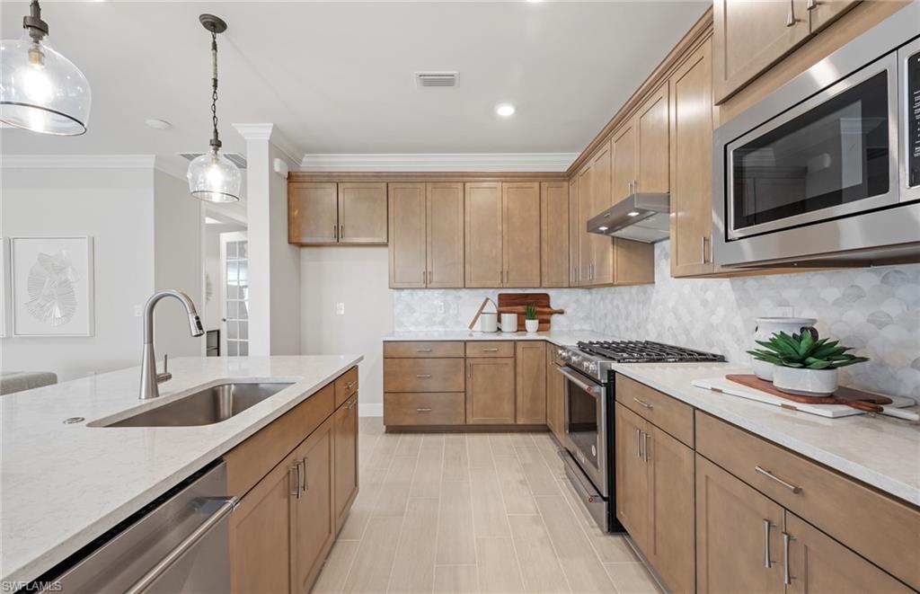 20322 Napa Loop Estero, FL 33928 - Photo 30 of 46 a kitchen with a sink stove and microwave