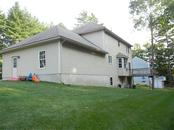 81 Clark Road Sturbridge, MA 01518 - Photo 21 of 21 a front view of a house with a garden