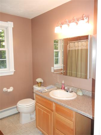 81 Clark Road Sturbridge, MA 01518 - Photo 10 of 21 a bathroom with a granite countertop sink toilet a large mirror and a window