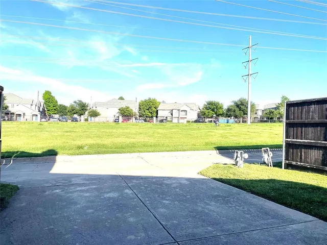 a view of a swimming pool and a yard