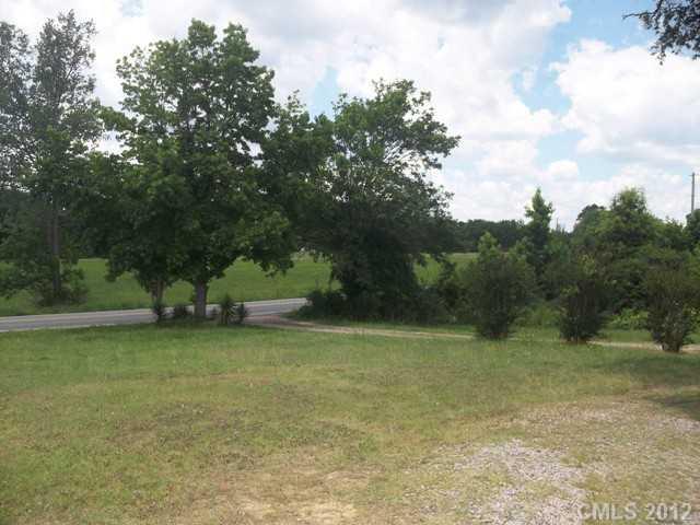 7515 Wolf Pond Road Monroe, NC 28112 - Photo 4 of 9 a view of a yard with a tree