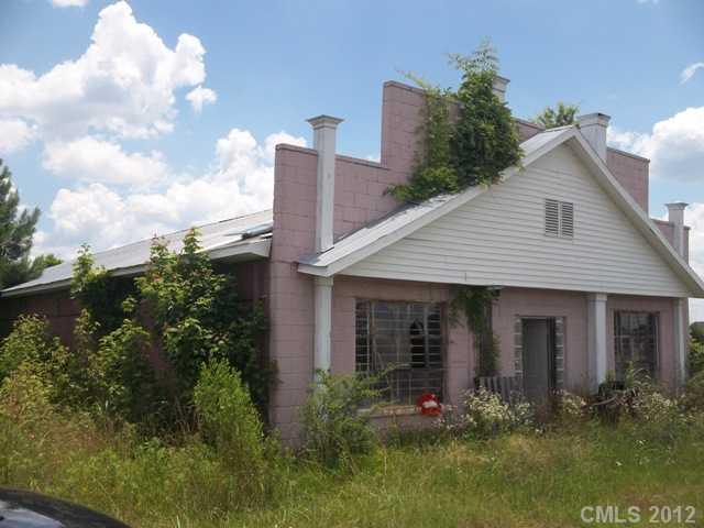 7515 Wolf Pond Road Monroe, NC 28112 - Photo 6 of 9 a front view of house with yard and green space