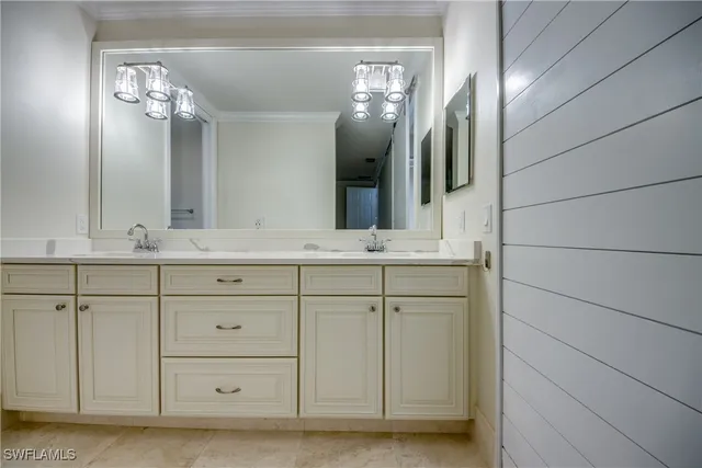 a bathroom with a double vanity sink mirror and