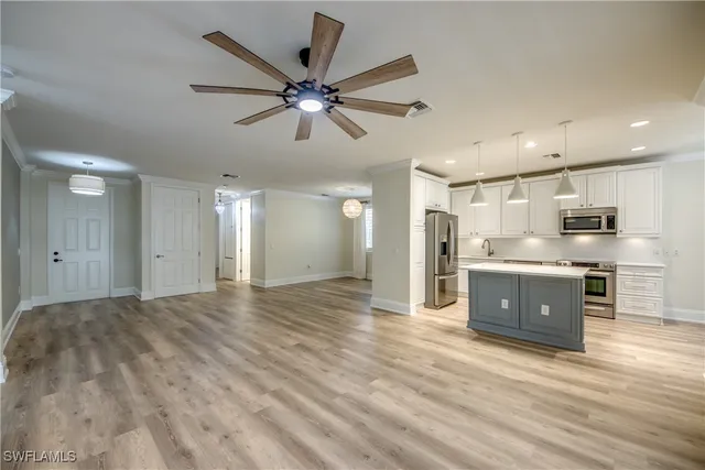 a view of a kitchen with a sink and microwave