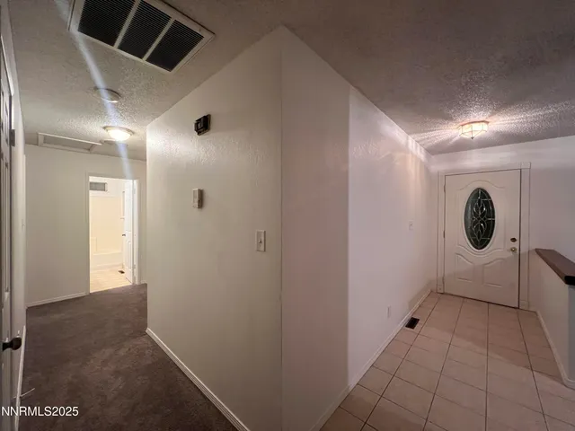 an empty room with closet and a ceiling fan