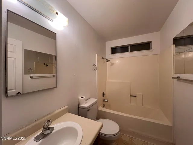 a white toilet sitting next to a bathroom sink