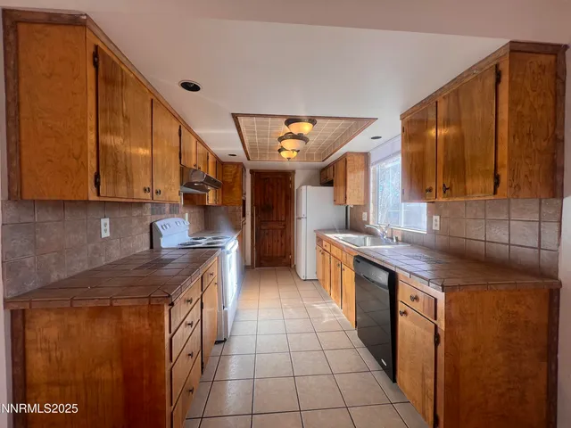 a kitchen with stainless steel appliances granite countertop a sink and a stove