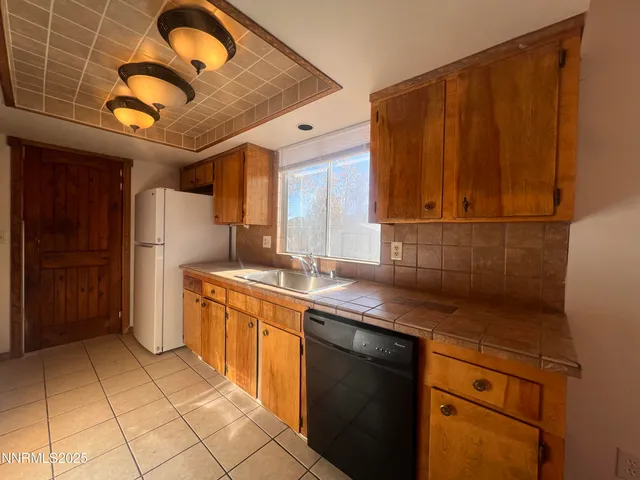 a kitchen with a sink cabinets and appliances