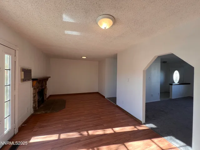 a view of a room with wooden floor