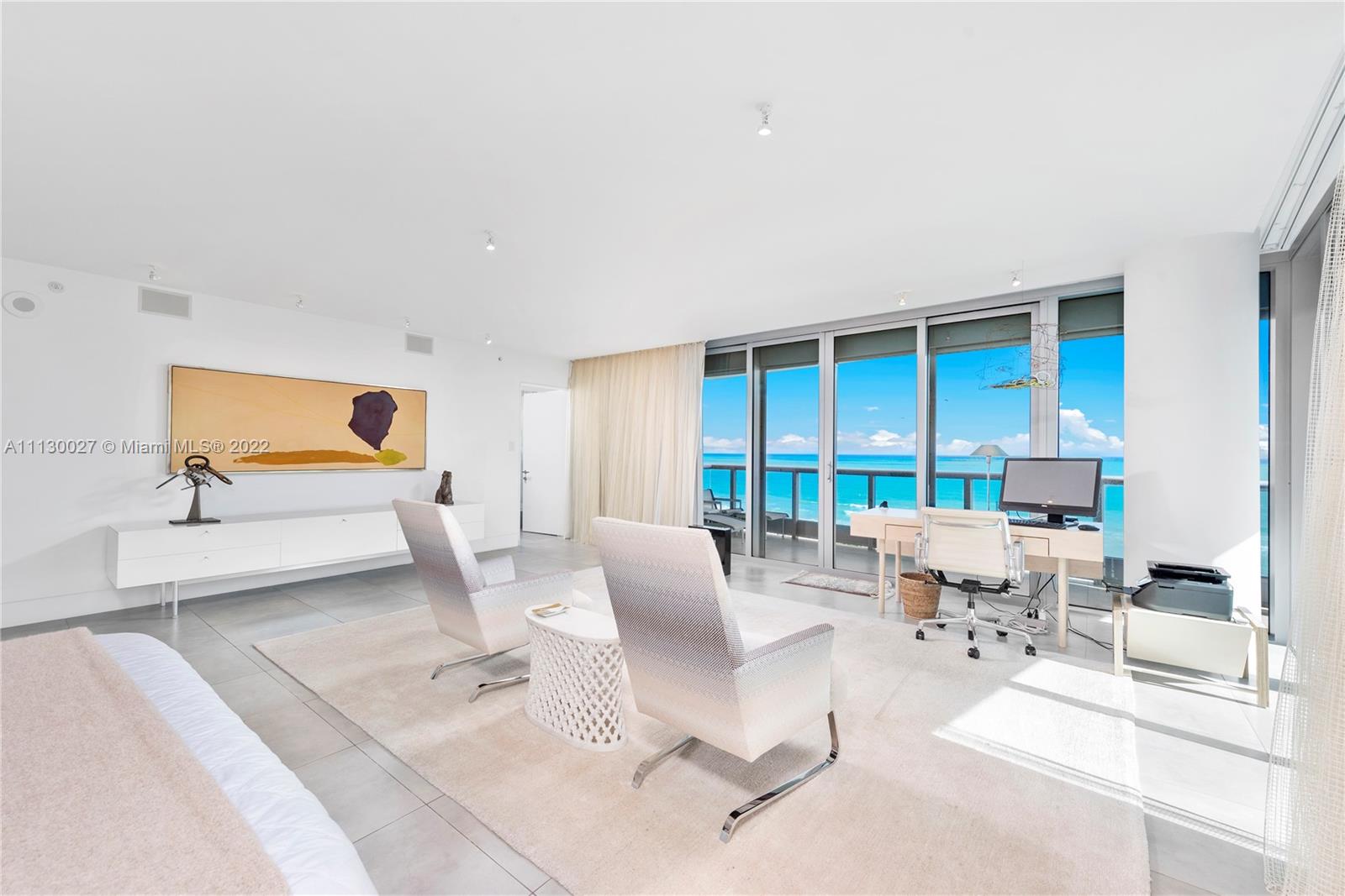 9401 Collins Avenue, Unit 607 Surfside, FL 33154 - Photo 17 of 58 a living room with furniture and floor to ceiling window