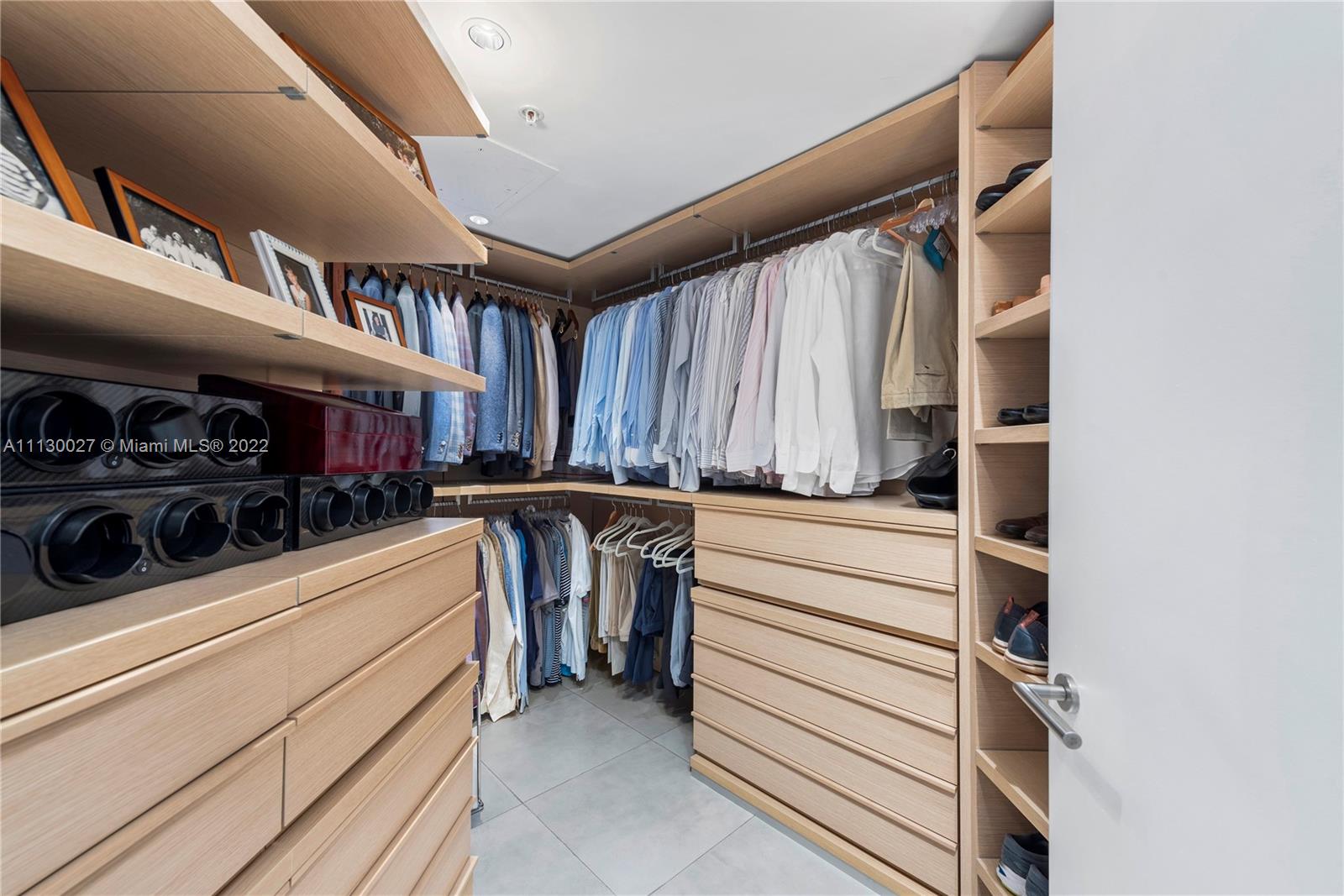 9401 Collins Avenue, Unit 607 Surfside, FL 33154 - Photo 24 of 58 a view of walk in closet with clothes and shoes