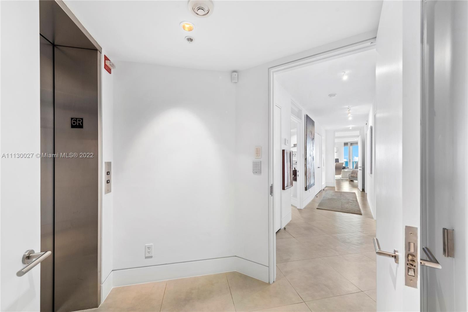 9401 Collins Avenue, Unit 607 Surfside, FL 33154 - Photo 32 of 58 view of a hallway with wooden floor and staircase