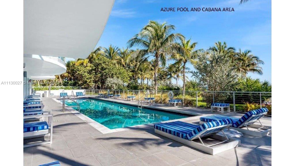 9401 Collins Avenue, Unit 607 Surfside, FL 33154 - Photo 38 of 58 a view of a swimming pool with a patio and a yard