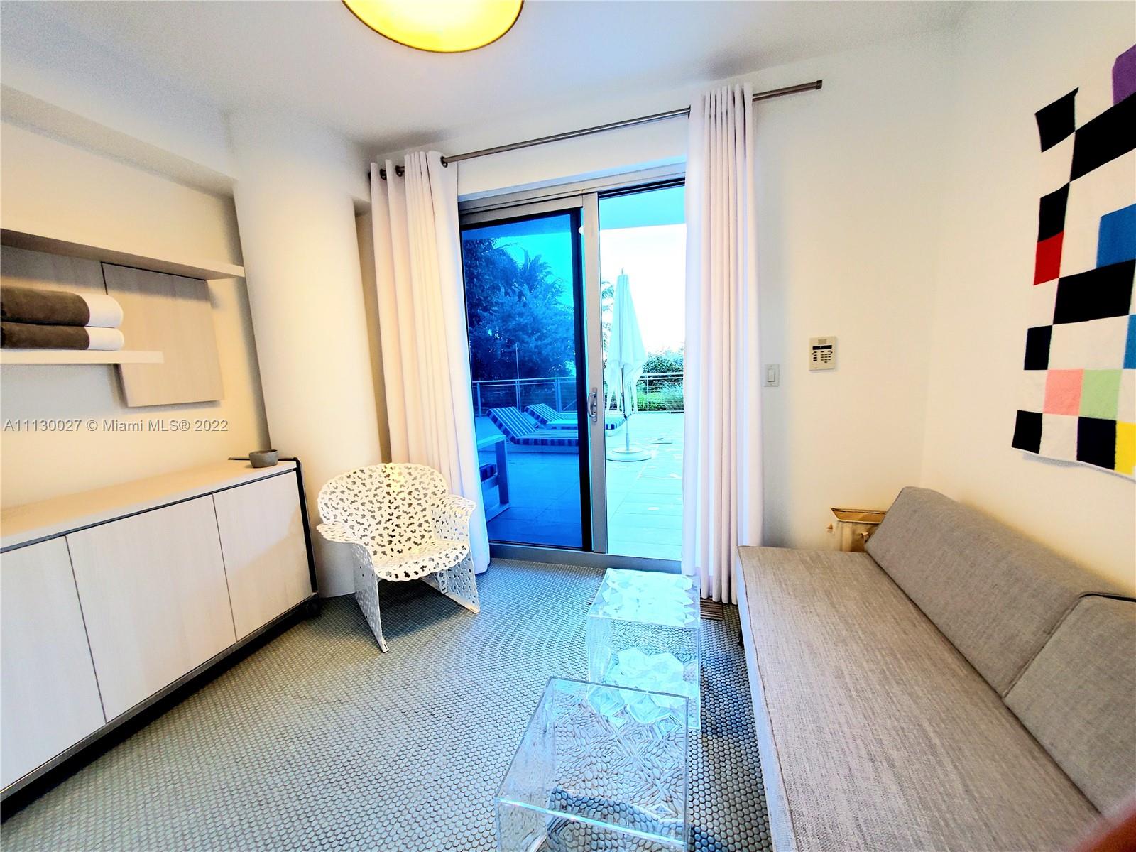 9401 Collins Avenue, Unit 607 Surfside, FL 33154 - Photo 41 of 58 a bedroom with a bed and a window