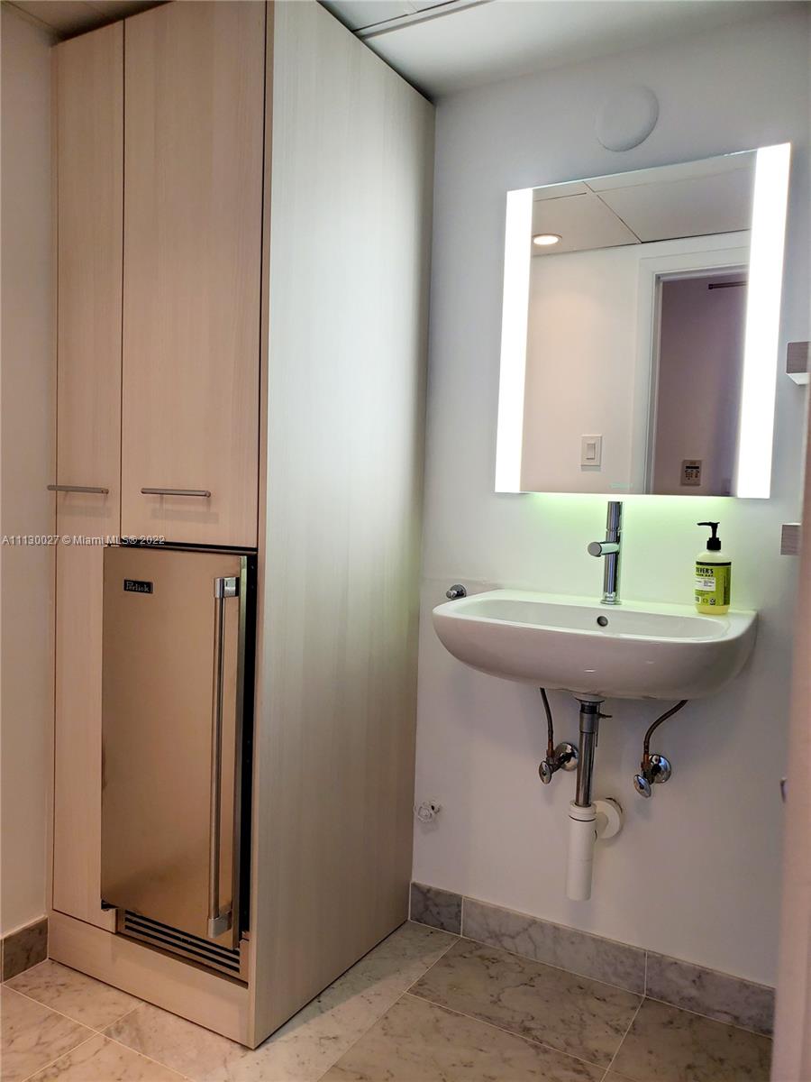 9401 Collins Avenue, Unit 607 Surfside, FL 33154 - Photo 45 of 58 a bathroom with a sink and a toilet