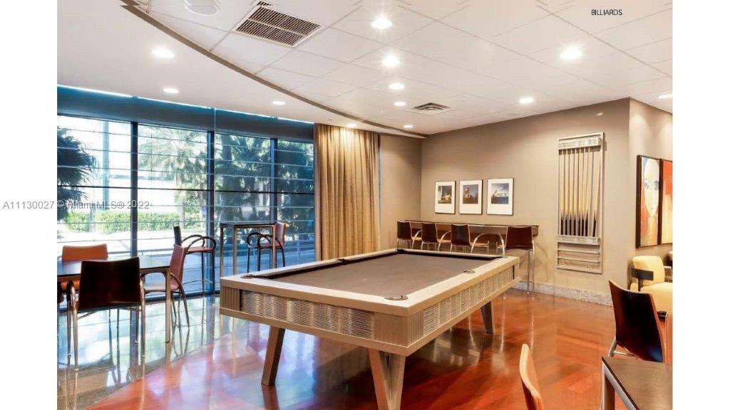 9401 Collins Avenue, Unit 607 Surfside, FL 33154 - Photo 48 of 58 a view of a dining room with furniture window and wooden floor