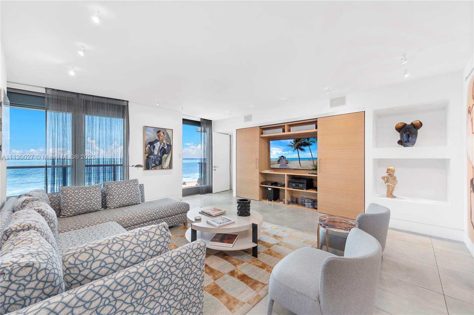 9401 Collins Avenue, Unit 607 Surfside, FL 33154 - Photo 8 of 58 a living room with furniture a rug and a large window
