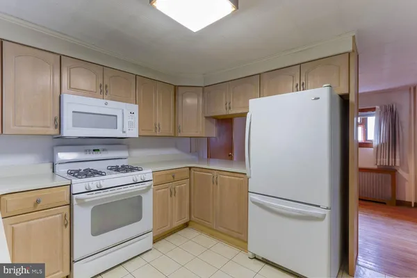a white refrigerator freezer and a stove in a kitchen