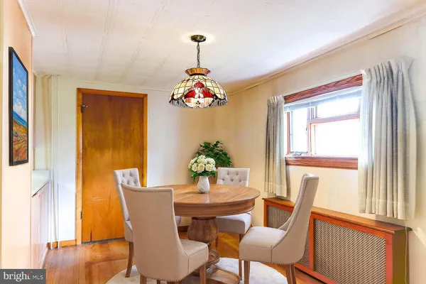 a dining room with furniture and window