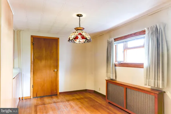 a very nice looking room with wooden floor and a window