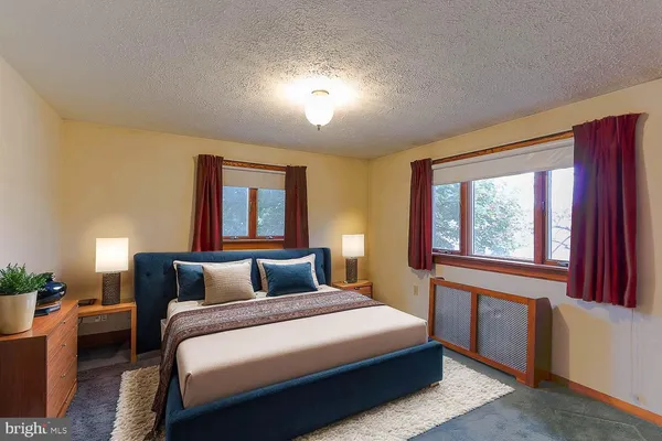 a bedroom with a large bed and a window with outer view