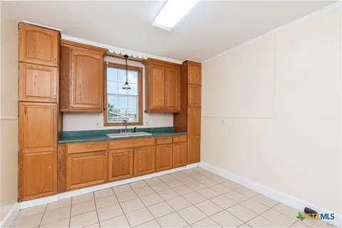 a bathroom with a granite countertop sink and mirror