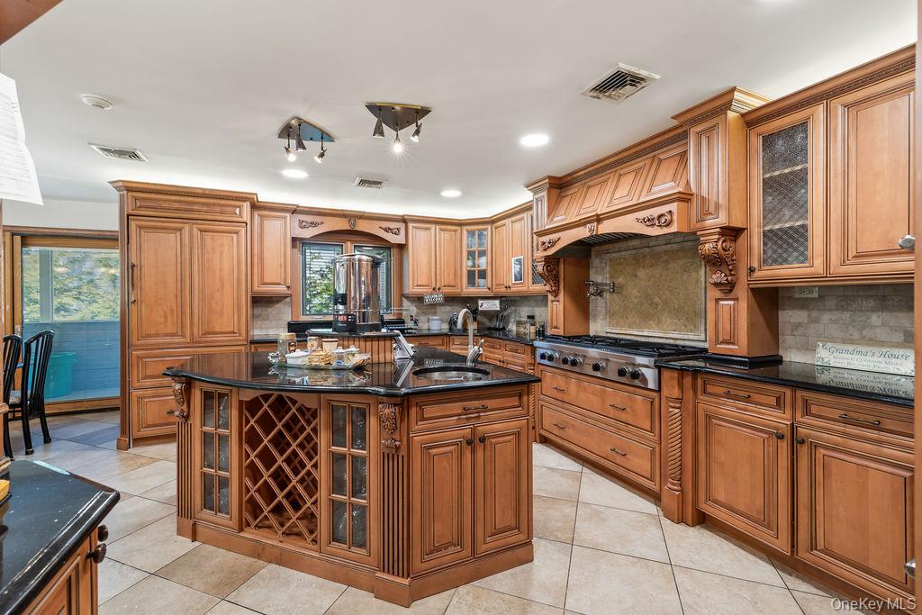 10 Elyise Road Monsey, NY 10952 - Photo 14 of 40 a kitchen with kitchen island granite countertop a sink counter top space appliances and cabinets