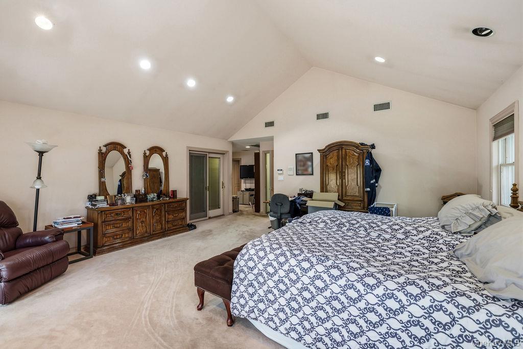 10 Elyise Road Monsey, NY 10952 - Photo 18 of 40 a bedroom with a large bed and wooden floor