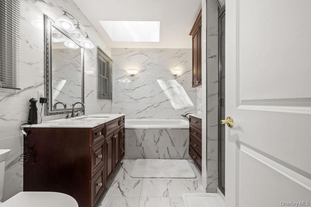 10 Elyise Road Monsey, NY 10952 - Photo 25 of 40 a bathroom with a sink vanity mirror and toilet