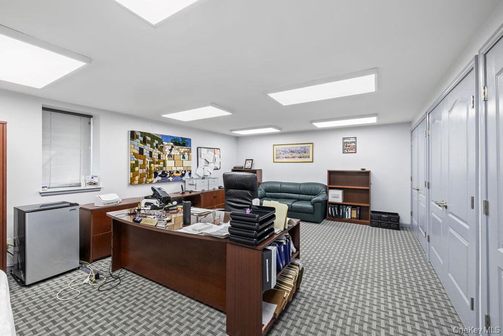 10 Elyise Road Monsey, NY 10952 - Photo 33 of 40 a room with furniture a flat screen tv and a table