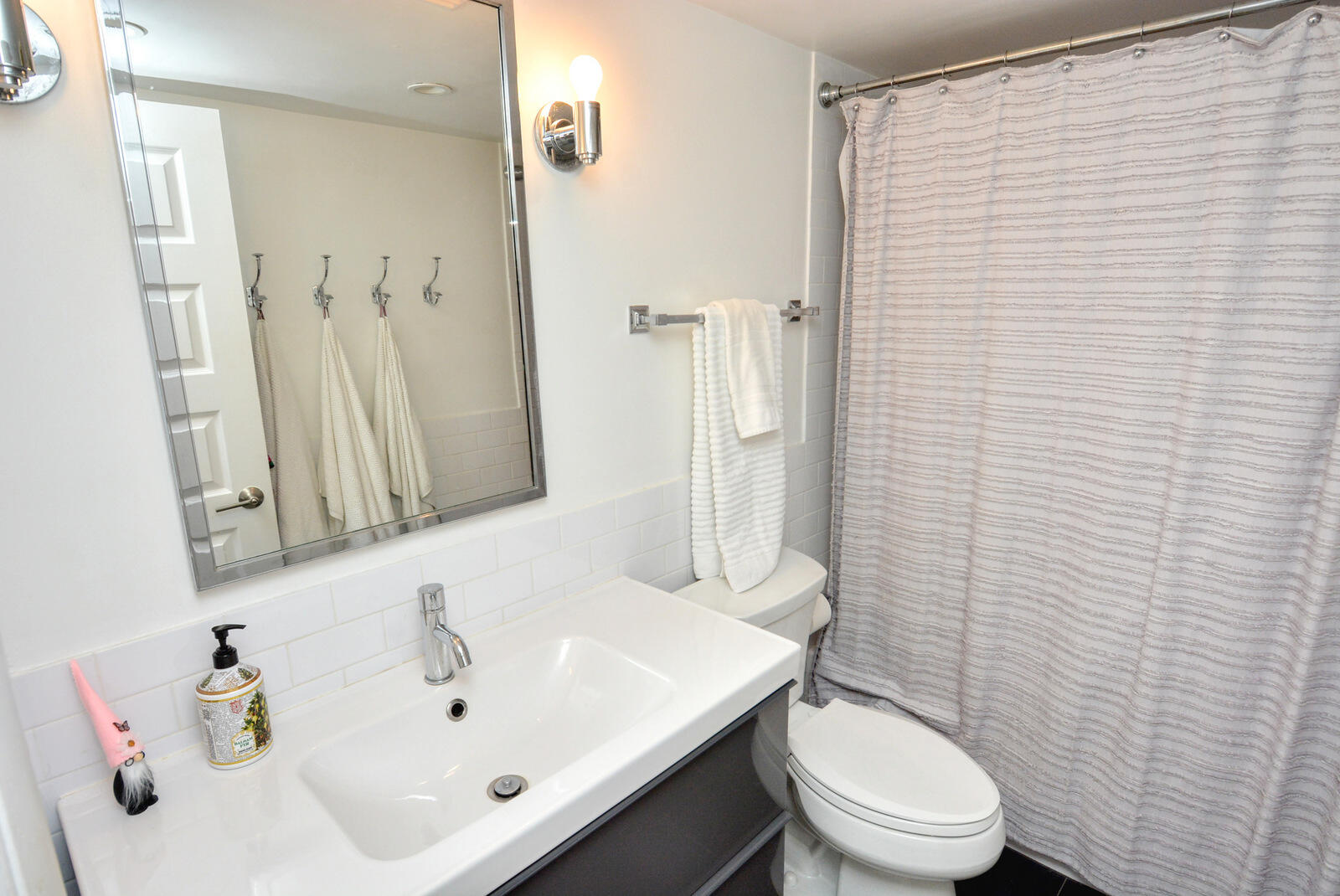 318 Golfview Circle Stuart, FL 34996 - Photo 21 of 39 a bathroom with a sink a toilet and shower curtain