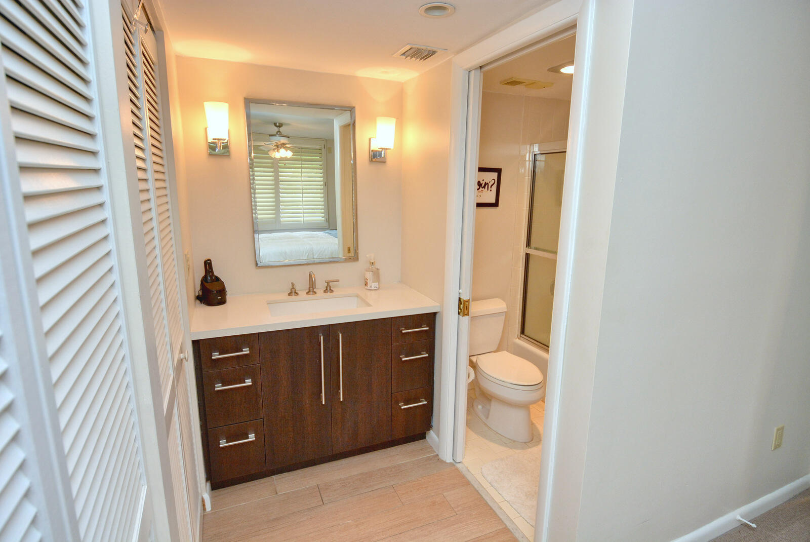 318 Golfview Circle Stuart, FL 34996 - Photo 27 of 39 a bathroom with a double vanity sink a toilet and a mirror