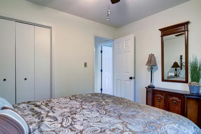 a bedroom with a large bed and a dresser