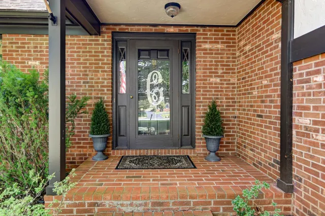 a view of a brick house with potted plants