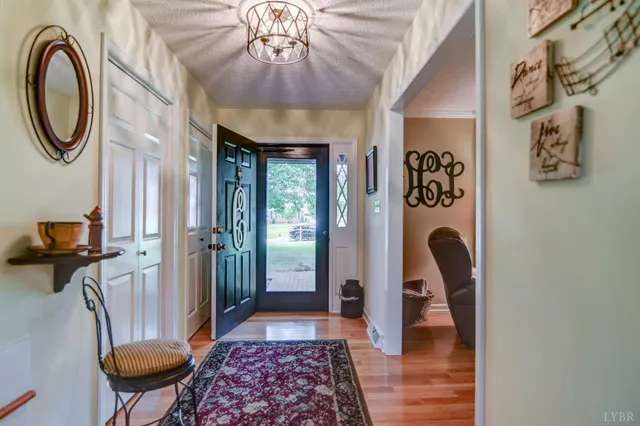a view of a hallway with furniture and paintings on the wall