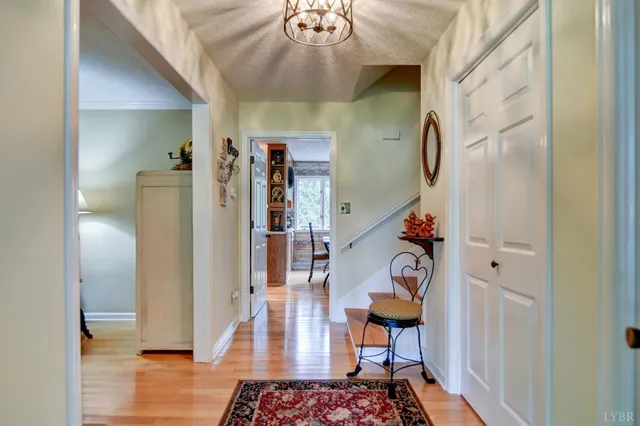 a view of entryway with furniture and wooden floor