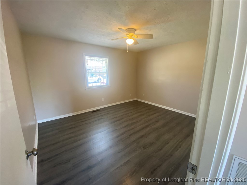 4959 B Fieldcrest Drive Fayetteville, NC 28303 - Photo 5 of 8 an empty room with wooden floor and windows