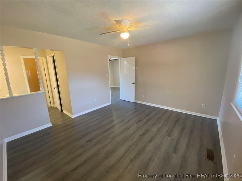 4959 B Fieldcrest Drive Fayetteville, NC 28303 - Photo 7 of 8 an empty room with wooden floor and a ceiling fan