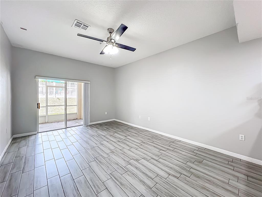 671 Sandy Neck Lane, Unit 102 Altamonte Springs, FL 32714 - Photo 14 of 37 a view of an empty room with wooden floor and a window