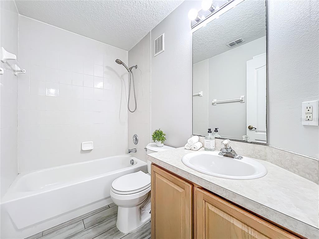 671 Sandy Neck Lane, Unit 102 Altamonte Springs, FL 32714 - Photo 22 of 37 a bathroom with a granite countertop sink a toilet and shower