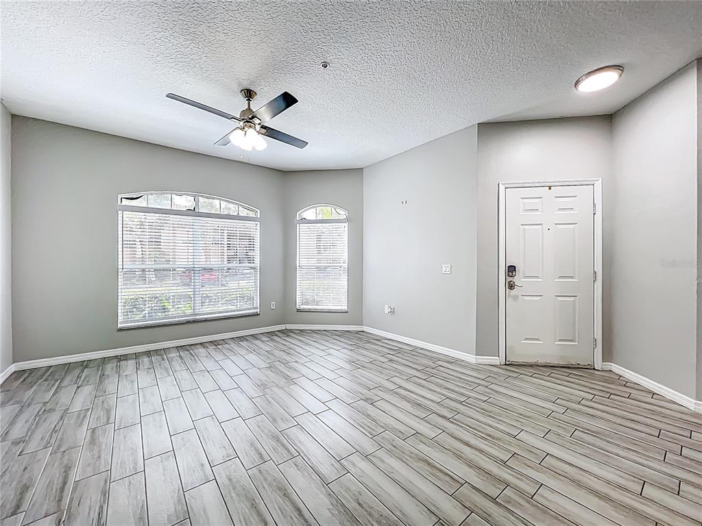 671 Sandy Neck Lane, Unit 102 Altamonte Springs, FL 32714 - Photo 5 of 37 wooden floor in an empty room with a window