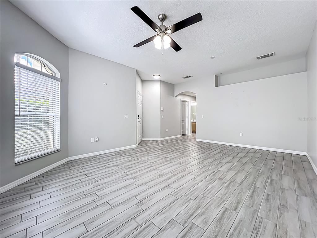 671 Sandy Neck Lane, Unit 102 Altamonte Springs, FL 32714 - Photo 7 of 37 an empty room with wooden floor and windows