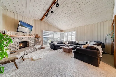 a view of empty room with floor to ceiling window and stairs