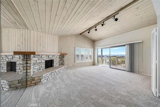 a view of a hallway with bathroom and a window