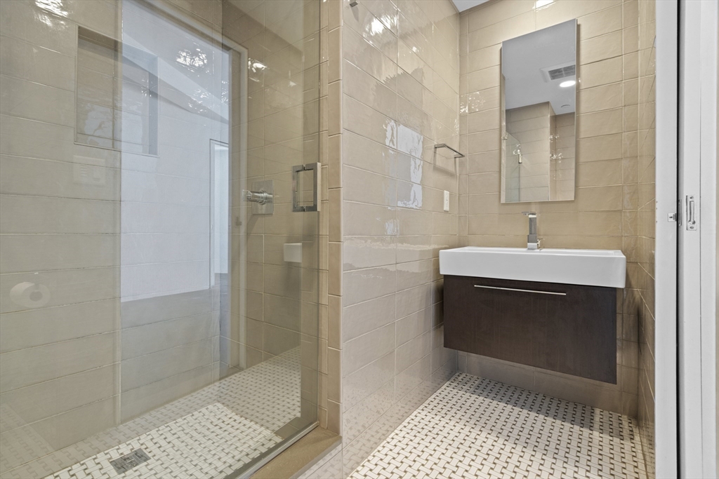 40 Fay Street, Unit 206 Boston, MA 02118 - Photo 4 of 9 a bathroom with a sink a toilet and shower