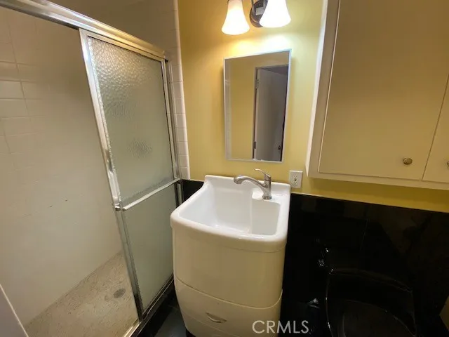 a bathroom with a sink and mirror