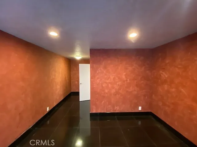 an empty room with wooden floor