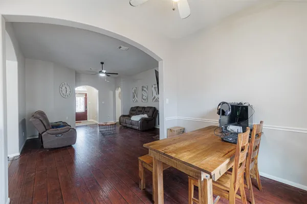 a living room with furniture a fireplace and wooden floor