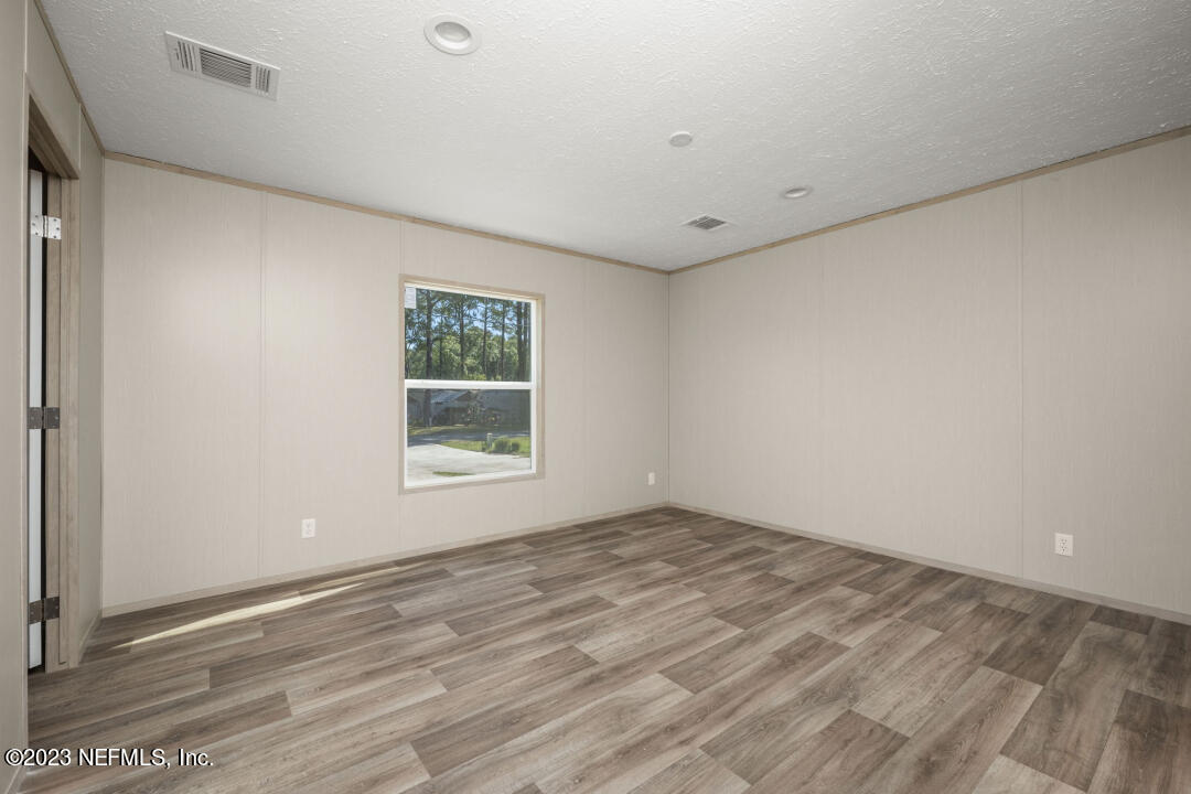 0 Chuck Road Jacksonville, FL 32221 - Photo 11 of 29 a view of an empty room with wooden floor and a window