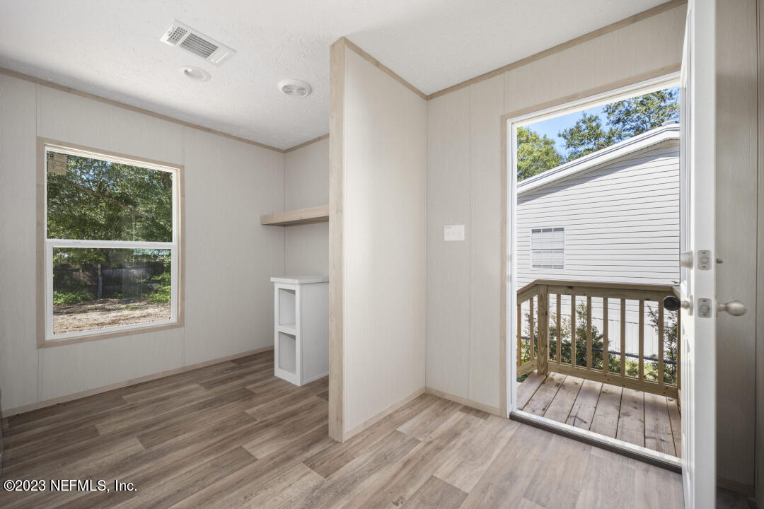 0 Chuck Road Jacksonville, FL 32221 - Photo 24 of 29 an empty room with wooden floor and windows